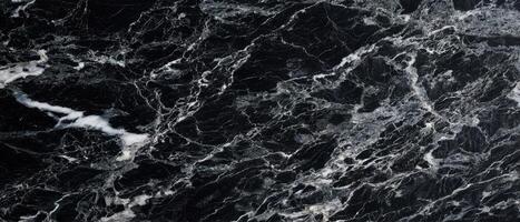 The captivating beauty of black marble with intricate white veining. photo