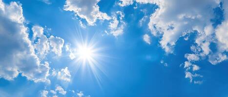 The Vibrant Sunlight Shining Through a Beautiful Blue Sky with Clouds photo