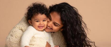 The joyful moment of a mother embracing her smiling baby. photo