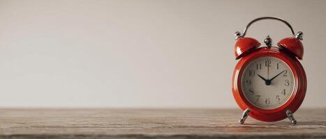 The Red Alarm Clock on a Rustic Wooden Table Capturing Simple Elegance photo
