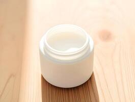 A white jar of cream sitting on a wooden table photo