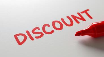 Discount word on white paper with red marker photo
