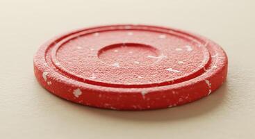 A red poker chip on a white surface photo