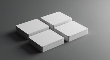 Four white cubes on a gray surface photo