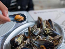 A delectable dish of fresh mussels served with a slice of lemon. photo