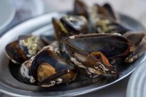 A delectable dish of fresh mussels served with a slice of lemon,. photo