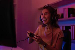 Joyful Gamer Engaged in Play. Young woman enjoying gaming experience on console. photo