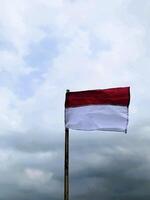 Indonesian flag with gray sky background during Indonesia independence day celebration photo
