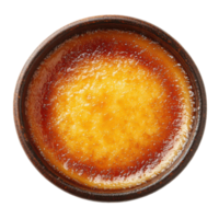 Golden caramel dessert on a rustic plate at a cozy cafe png