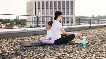 Mother and daughter practicing yoga video