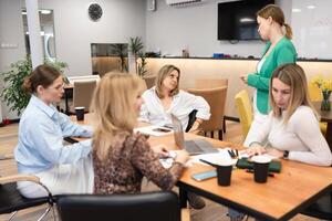 Businesswomen Meeting Office Discussion Collaboration Teamwork in bright office during daytime, for brainstorming. photo