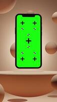 Vertical Animation of Smartphone with Green Chroma Key Screen on a Platform Surrounded by Balls with Peach Background video