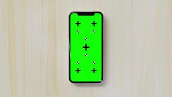 Animation of Smartphone with Green Chroma Key Screen on a Wooden Table video