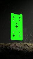 Vertical Animation of Smartphone with Green Chroma Key Screen Inside a Dark Cave video