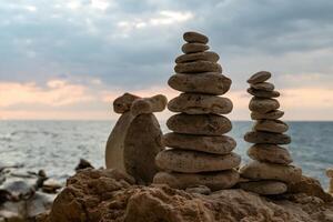 Stone Stacks Beach Sunset - Three stone stacks on a beach at sunset. photo