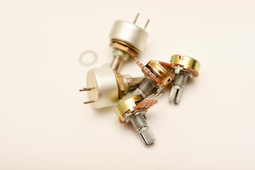 Close-up of metal potentiometers with nuts. Potentiometers. Variable resistors. Devices for voltage changes. photo