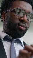 Happy African American businessman in office smiling using digital tablet modern technology business man smiling success professional male manager corporate entrepreneur innovation working internet video