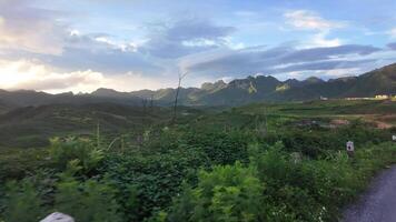 Beautiful mountain view with forest on the horizon from the window of a moving car. Landscape of Laos. video