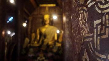 A large golden Buddha statue at Wat Xieng Thong, one of the most famous tourist attractions in Luang Prabang, Laos. video