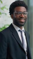 African American man business guy male businessman looking in window smiling at camera portrait in office employer manager company CEO investor indoors smile success ethnic entrepreneur satisfied video