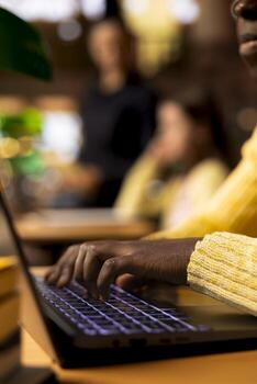 Student working on a foreign language assignment in the campus library, consulting books and dictionaries to finish the homework project. Productive study habits and research at desk. Close up. photo