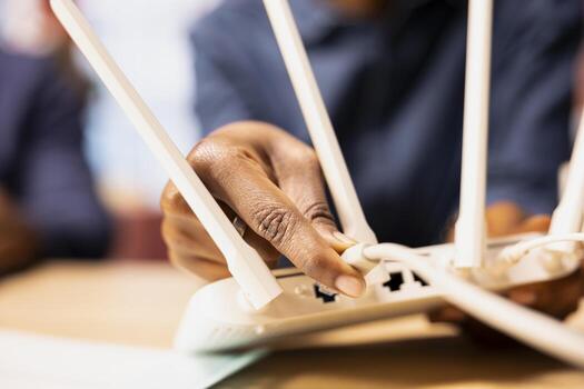 African American couple in a loft struggles with an unstable network, brainstorming solutions to troubleshoot the wireless router and improve connection speed for business tasks at home. Close up. photo