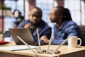 African American people struggling to work with internet lag issues at home, testing LAN cables and adjusting Wi Fi settings to restore connectivity and keep their digital business running smoothly. photo