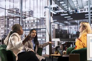 Diverse women executives in a modern office discussing business growth, career development and gender equality. Powerful leaders in action uniting forces to expand the enterprise, progression. photo