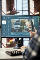Man in home office using generative artificial intelligence website generating videos using diffusion models. Person having conversation with AI virtual assistant producing clips photo