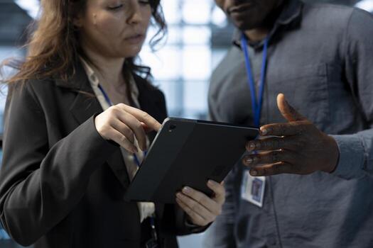 Data center software developers using laptop, conducting security audits, preventing errors. Close up of coworkers doing brainstorming, using device to review firewall rules, logging incident details photo