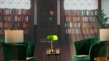 Empty book filled traditional study room with green armchairs and warm wood tones exudes a cozy upscale atmosphere. Space ideal for elite aristocracy gatherings and drinking whiskey. photo