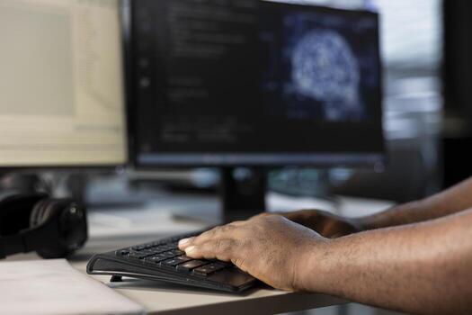 Engineer typing on keyboard, doing data center automation using AI and machine learning tools. Close up of IT expert integrating artificial intelligence driven automation in server room operations photo