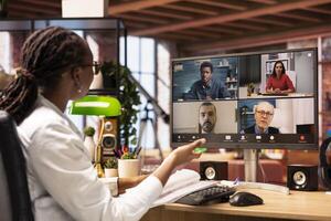 Manager talks with employees during videocall from home, looking over paperwork, organizing job shifts. Supervisor doing remote teleconference meeting with staff members, checking documents photo