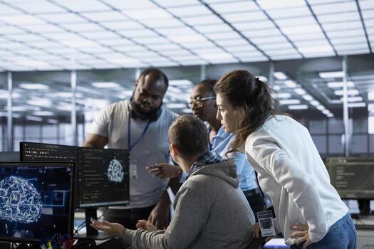 Engineer doing brainstorming with colleagues to fix error in code affecting server room AI workloads. Team of artificial intelligence experts repairing data center systems together photo
