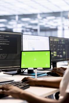 System administrator in server hub ensuring data remains shielded from potential threats using mockup tablet. African american worker safeguarding data center against hackers with green screen device photo