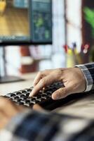 Freelancing interior designer in home office uses assets from 3D modeling application digital library. Close up of man selecting from catalog of design elements in architectural software photo