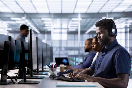 Engineer hearing podcasts to make time pass faster while working in server farm to optimize it for data processing requirements. IT expert listens songs and ensures data center operates efficiently photo