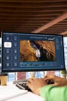 Man at home using generative artificial intelligence website generating videos using diffusion models. Person in apartment using AI virtual assistant producing clips, close up shot photo