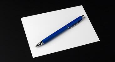 A blue pen on top of a piece of paper photo