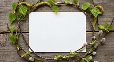 A blank sheet of paper surrounded by branches and leaves photo
