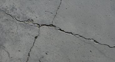 A close up of a crack in a concrete wall photo
