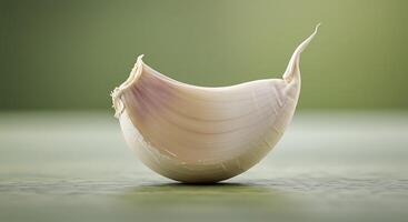 A garlic bulb on a green surface photo
