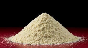 A pile of white powder on a red surface photo