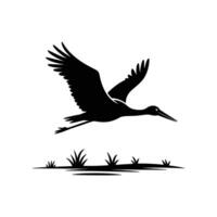Black and white silhouette of a crane flying over grass vector