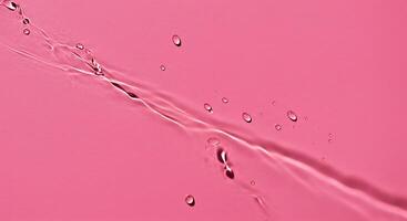 Water droplets on a pink background photo