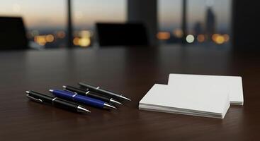 Business cards and pens on a table with city lights in the background photo