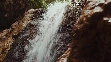 Refreshing Waterfall Cascading Down Mossy Rocks in Lush Forest. photo