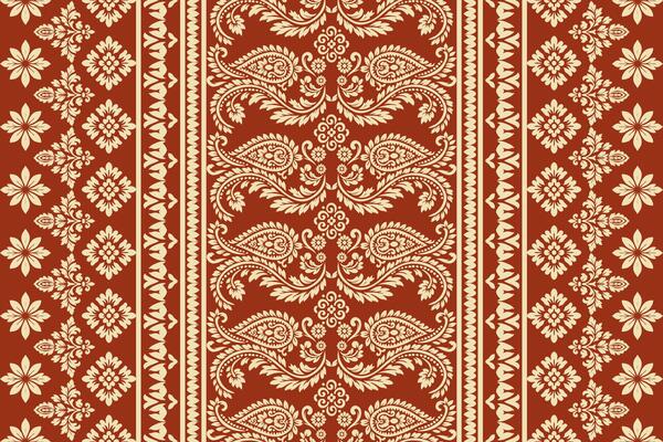 Seamless ethnic ikat paisley and floral embroidery pattern with decorative Indian, Aztec, African boho border motifs, traditional textile design for fabric, clothing, wallpaper, and decor.