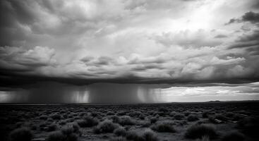 A black and white photo of a storm over a desert