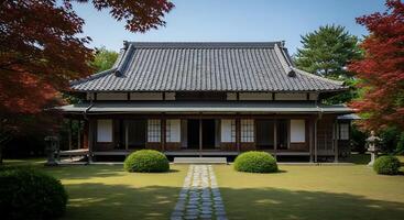 A japanese style house with a large roof and a path photo